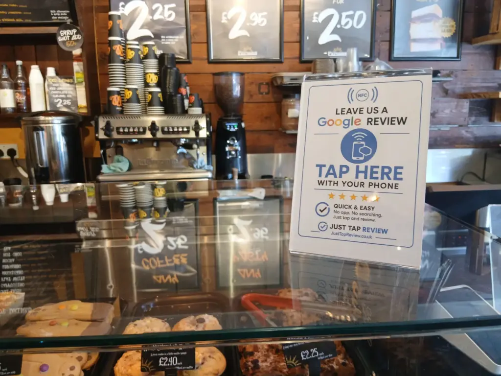 NFC Google review stand on the counter at a local café
