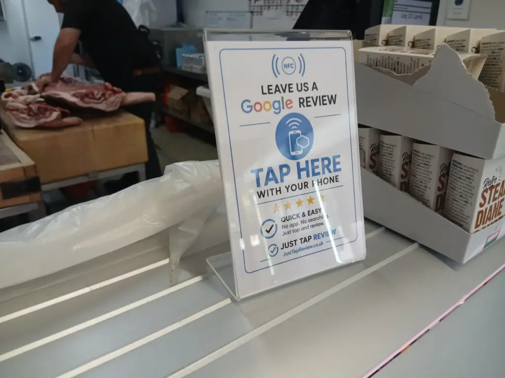 Google review stand on the counter at a local butcher shop